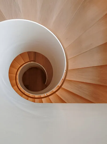 Sculptural spiral staircase in warm timber